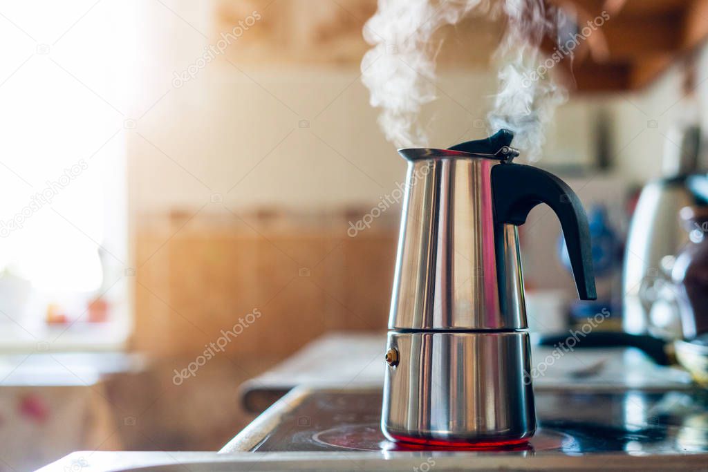 Geyser coffee maker on an electric stove in the kitchen in the morning