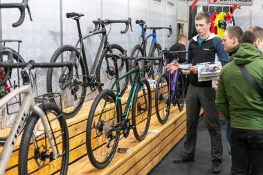 Kyiv, Ukraine, February 28, 2020: bike Expo 2020, the seller stands near the bikes showing them to customers