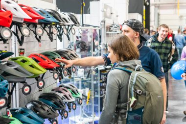 Kyiv, Ukraine, February 28, 2020: buyers choose bicycle helmets at the bike expo 2020.