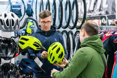Kyiv, Ukraine, February 28, 2020: buyers choose bicycle helmets at the bike expo 2020.