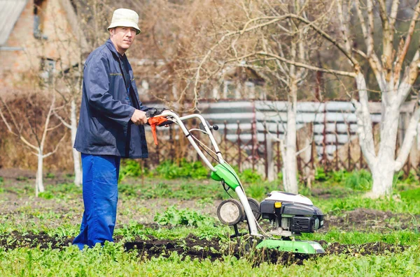 Een Man Cultiveert Het Land Met Een Cultivator Een Lentetuin — Stockfoto