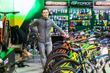 Kyiv, Ukraine, February 28, 2020: bike Expo 2020, the seller stands near the bikes showing them to customers