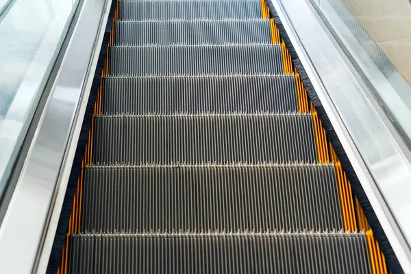 Empty escalator stairs in a mall or subway.