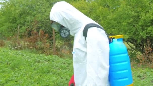 Trabalhador que difunde herbicida em plantas no campo — Vídeo de Stock