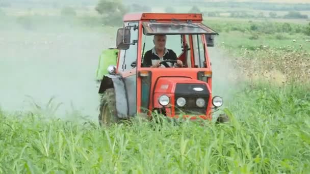 Agrimotor riding and spreading herbicides on field — Stock Video