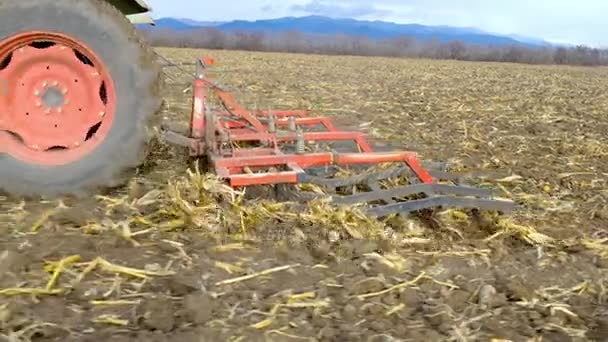 Tractor cultivating ground of agro field — Stock Video