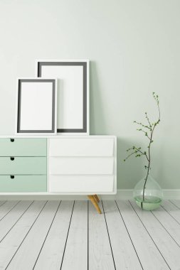 Dikey poster komodinin üzerinde beyaz bir çerçeve ile sahte