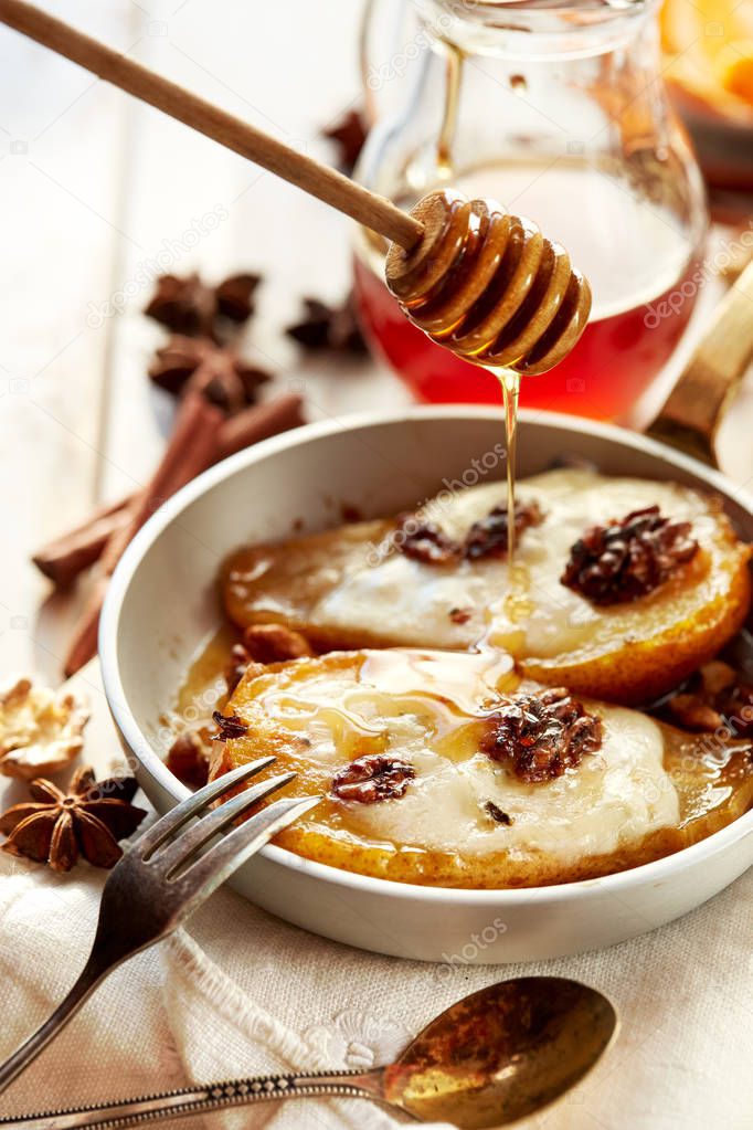 Baked pears with honey stuffed with gorgonzola cheese and walnuts