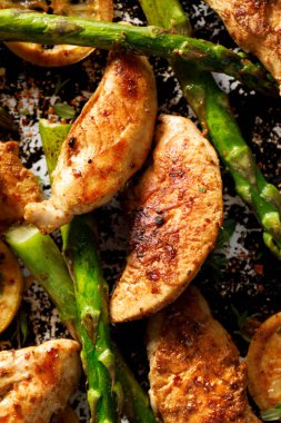 Grilled green asparagus with chicken breast and lemon clipart
