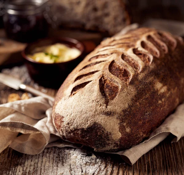 Rustic sourdough bread on wooden table — Stock Photo, Image