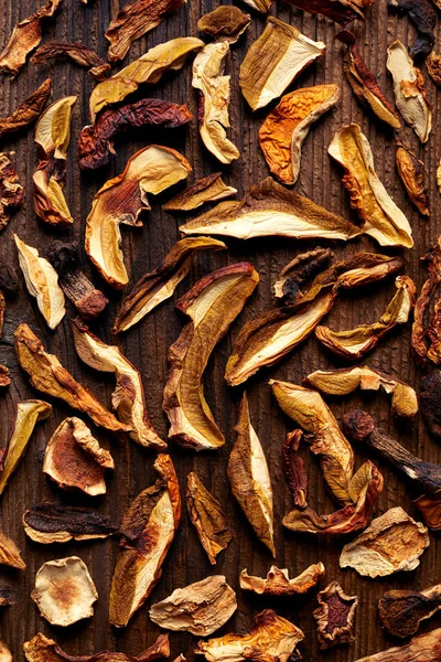 Dried forest mushrooms sliced on wooden background — Stock Photo, Image