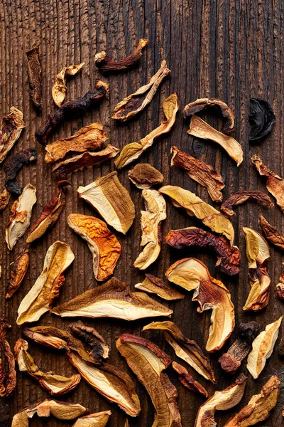 Ahşap arka plan üzerinde kurumuş orman mantar dilimlenmiş