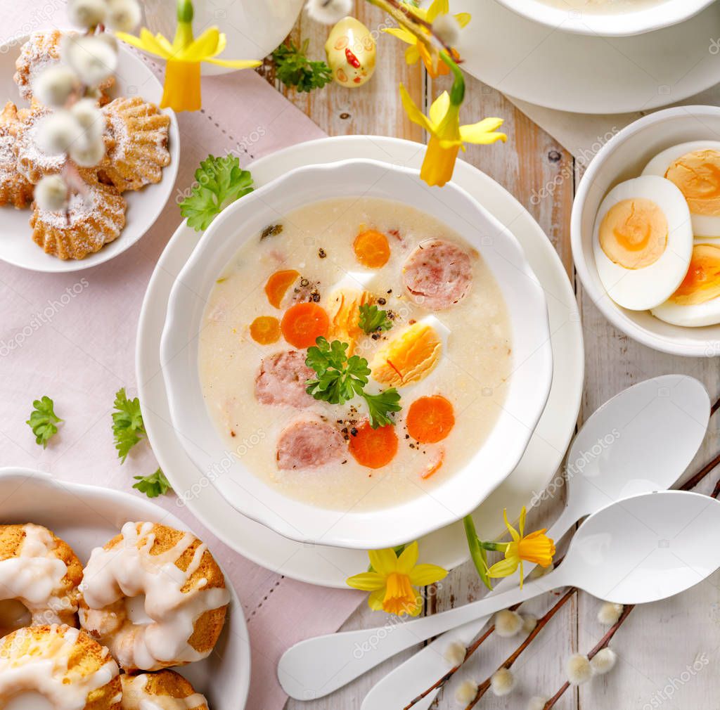 Polish Easter soup, white borscht with the addition of white sausage and a hard boiled egg,  top view, traditional Easter dish in Poland