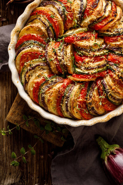 Vegetable tian, Provencal vegetable casserole. Delicious and nutritious traditional vegetarian meal, top view, close up