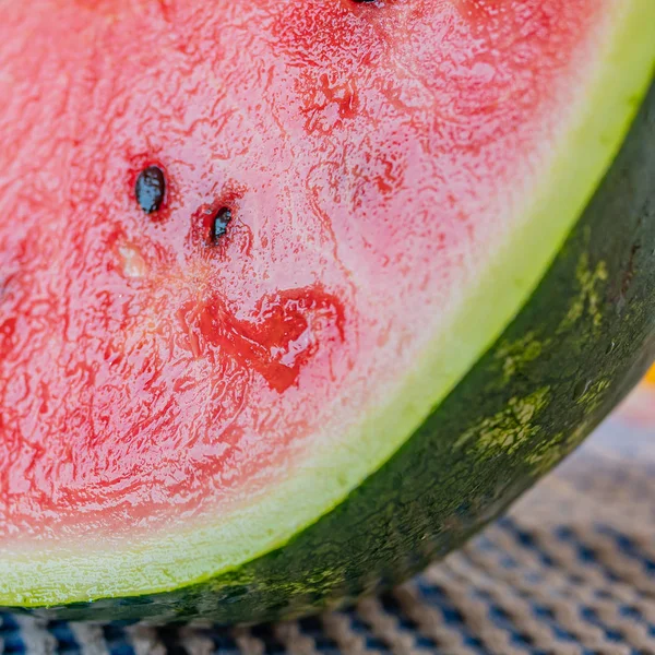 Fresh and clean cut watermelon with blurred background. Concept of freshness and summer time on the beach. — Stockfoto