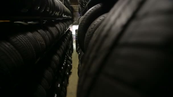 Large wooden structure for wheels in which many wheels on shelves — Stock Video