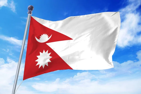 Flag of Nepal developing against a clear blue sky — Stock Photo, Image