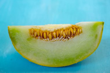 Mavi ahşap arka plan üzerinde kavun parçaları