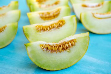 Mavi ahşap arka plan üzerinde kavun parçaları