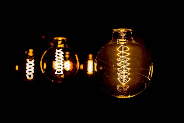 Modern light bulb on black background — Stock Photo, Image