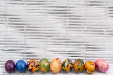Beyaz ahşap arka plan üzerinde renkli Paskalya yumurtaları