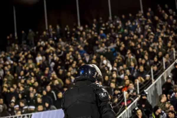 The police at the stadium event secure a safe match against the hooligans