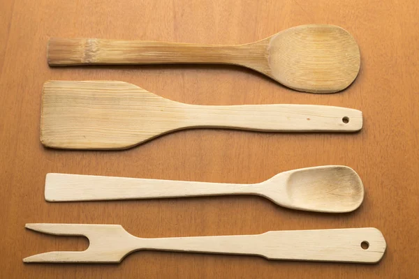 Wooden kitchen utensils placed on table — Stock Photo, Image