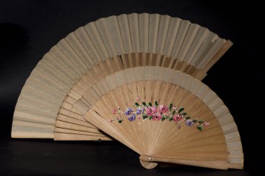 Siyah arka planda iki tahta vantilatör.