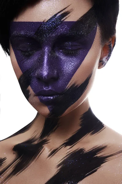 Purple and black Paint Makeup on Face of Model