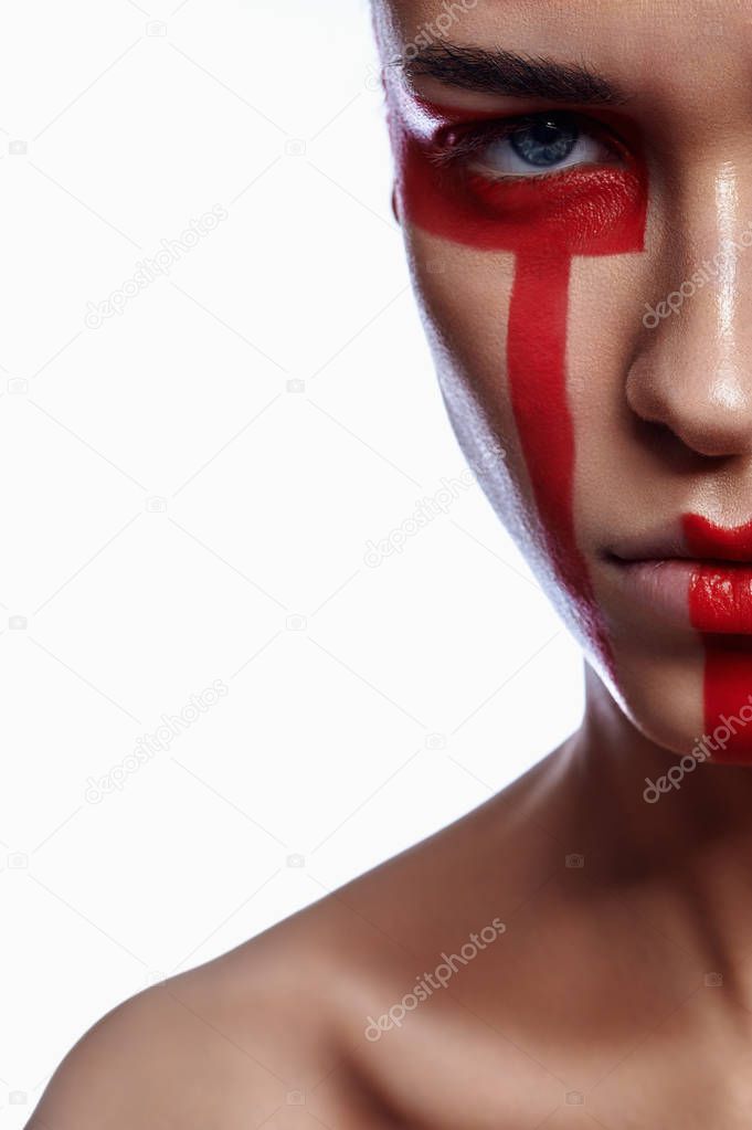 Half Face of Woman with tribalistic red Make-up