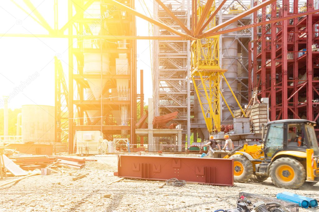 Industrial Construction. Workers Assemblers On The Excavator On The Construction Of An Industrial Facility. Tinted Image. Selective Focus