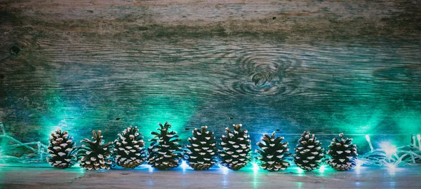 Fundo de madeira velho com cones de pinheiro de abeto e guirlanda com espaço para texto. o conceito de Natal de Ano Novo. foto matizado — Fotografia de Stock