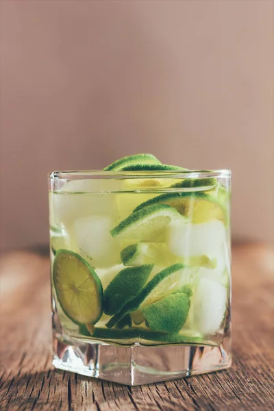 Освежающий напиток с зеленым лимоном и льдом вблизи, тонированное фото — стоковое фото