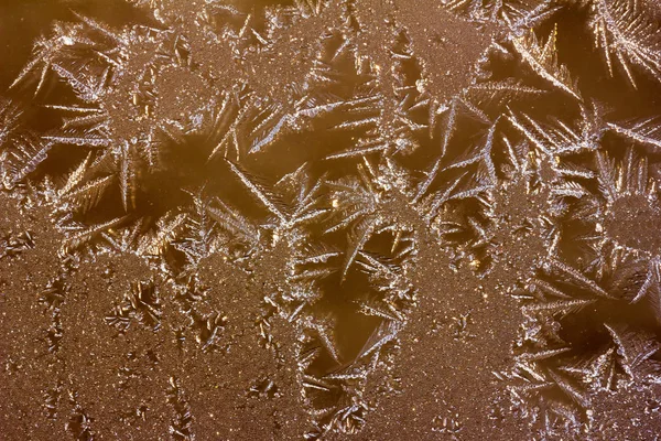 Abstrato textura de fundo dos padrões de gelo em vidro, foto matizada — Fotografia de Stock