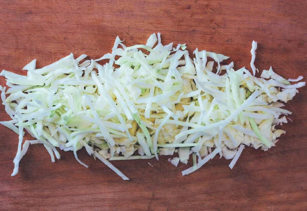 Sliced raw cabbage on an old cutting Board. top view close up, tinted photo — Stock Photo, Image