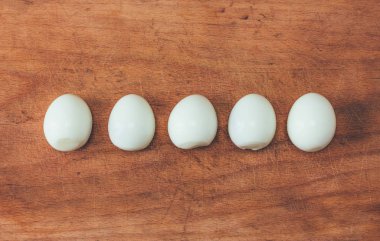 beş üst üste bir eski kesme tahtası üzerinde soyulmuş yumurta pişirdim. yakın çekim fotoğraf tonlama yukarıda görüntülemek