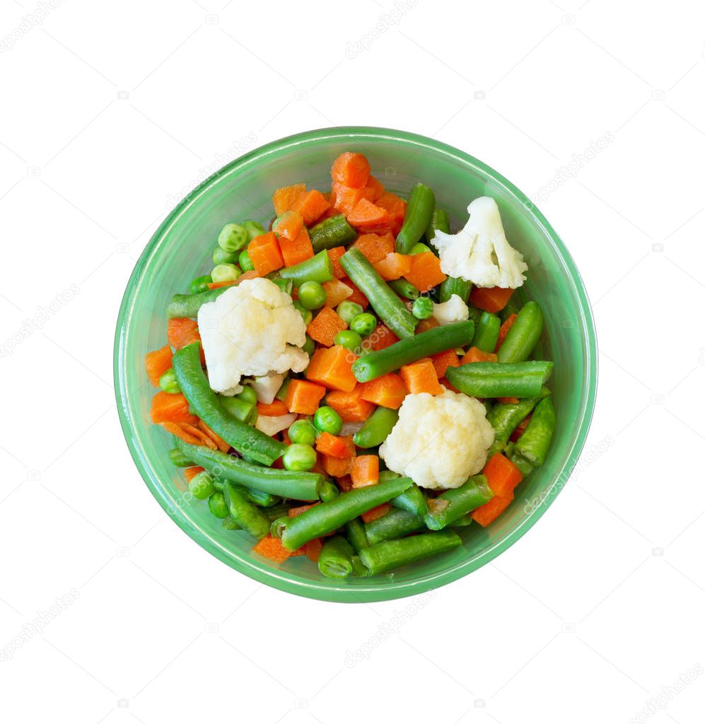 Asian cuisine. vegetable mix of carrots, peas, green beans and cauliflower in green plate, close-up view from above isolated on white background