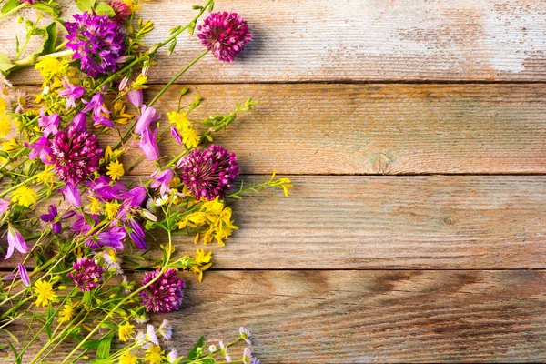 Wilde bloemen op een houten rustieke vintage achtergrond met ruimte voor tekst — Stockfoto