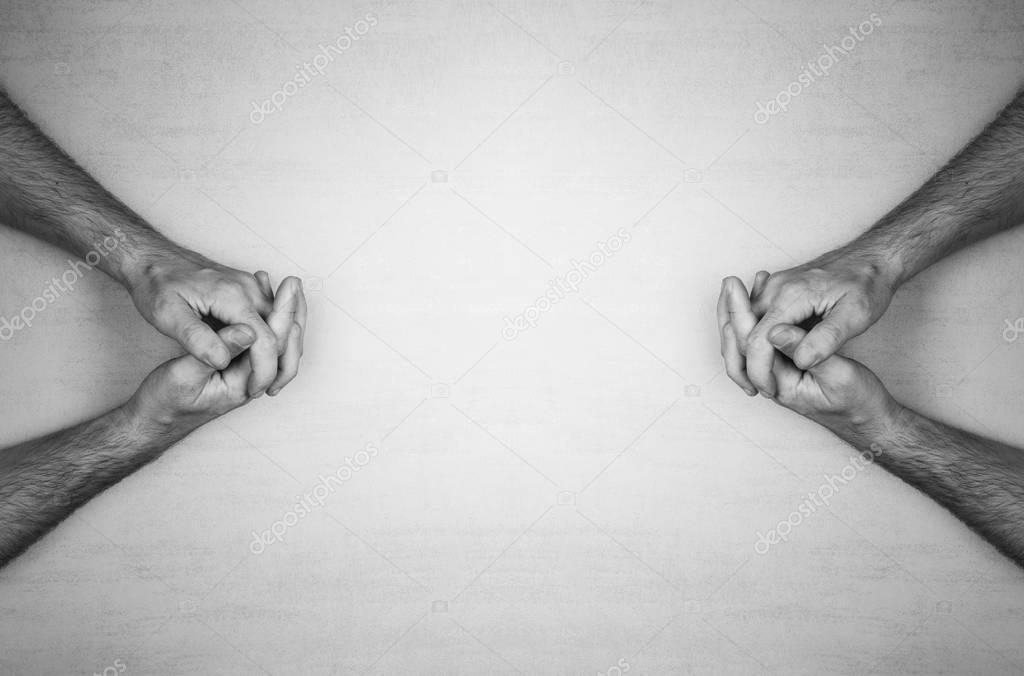 hands of a man are folded into a lock on a gray background, top view. black and white photo. mock up for text, phrases, lettering