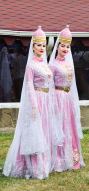  young girls Circassian in Adyghe traditional costumes at the festival of cheese Adyghe in Adygea clipart