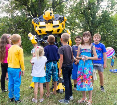  children have fun and play with the animator in costume transformer bumblebee clipart