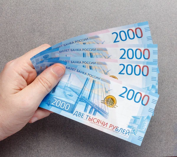 Nowy Rosyjski Banknoty 2000 Rubli Męskie Ręce Zbliżenie Szarym Tle — Zdjęcie stockowe