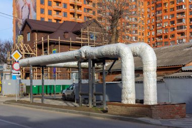 Krasnodar, Russia - February 11, 2020: Overhead heat pipes. A pipeline above ground that conducts heat for heating urban homes