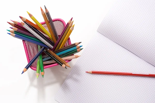 Colored pencils and copybook — Stock Photo, Image