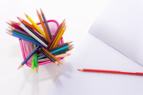 Colored pencils and copybook — Stock Photo, Image