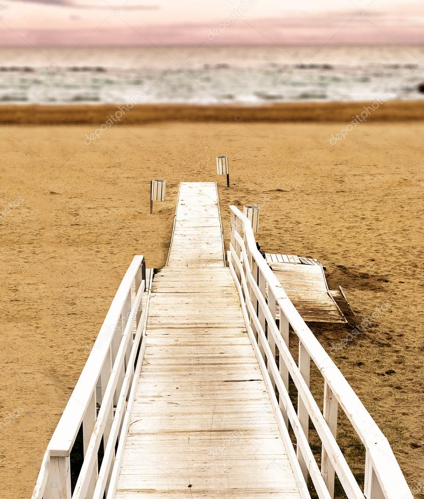 Boardwalk on the beach at sunset