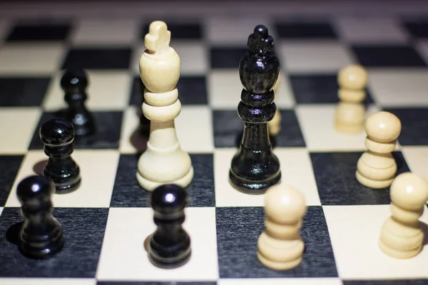the chessboard with Black King and white King in front in the concept of agreement with arounds pawns.