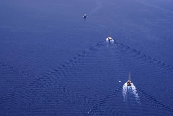 White sailing boat against a pure blue mediterranean sea