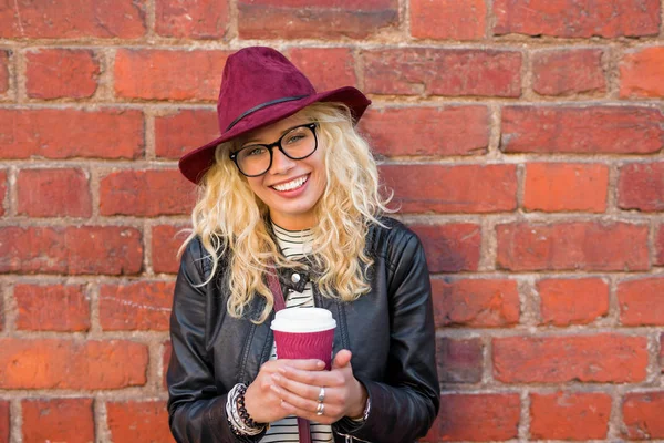 Hipster woman with coffee cup in her hands