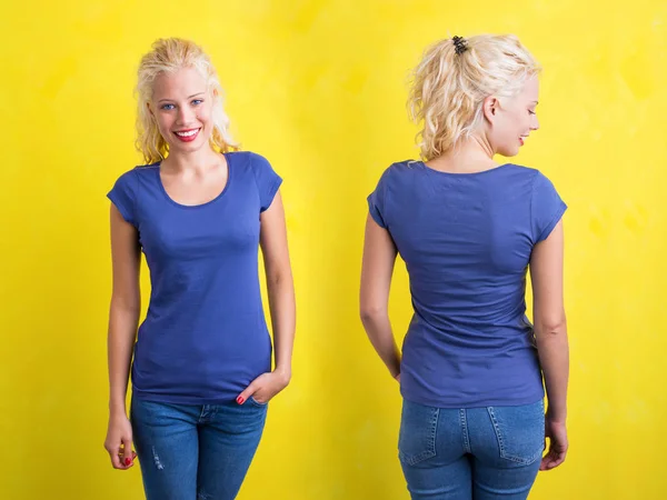 Woman in blue round neck T-shirt on yellow background — Stock Photo, Image